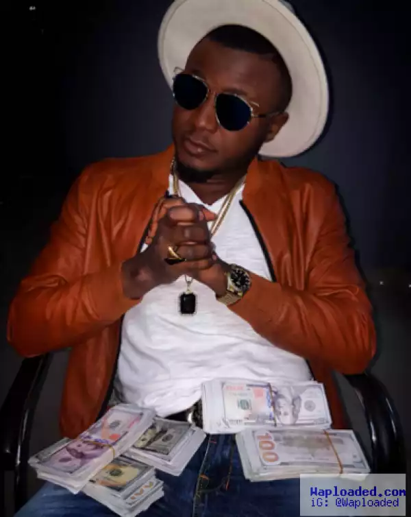 Singer MC Galaxy pose with wads of foreign currency
